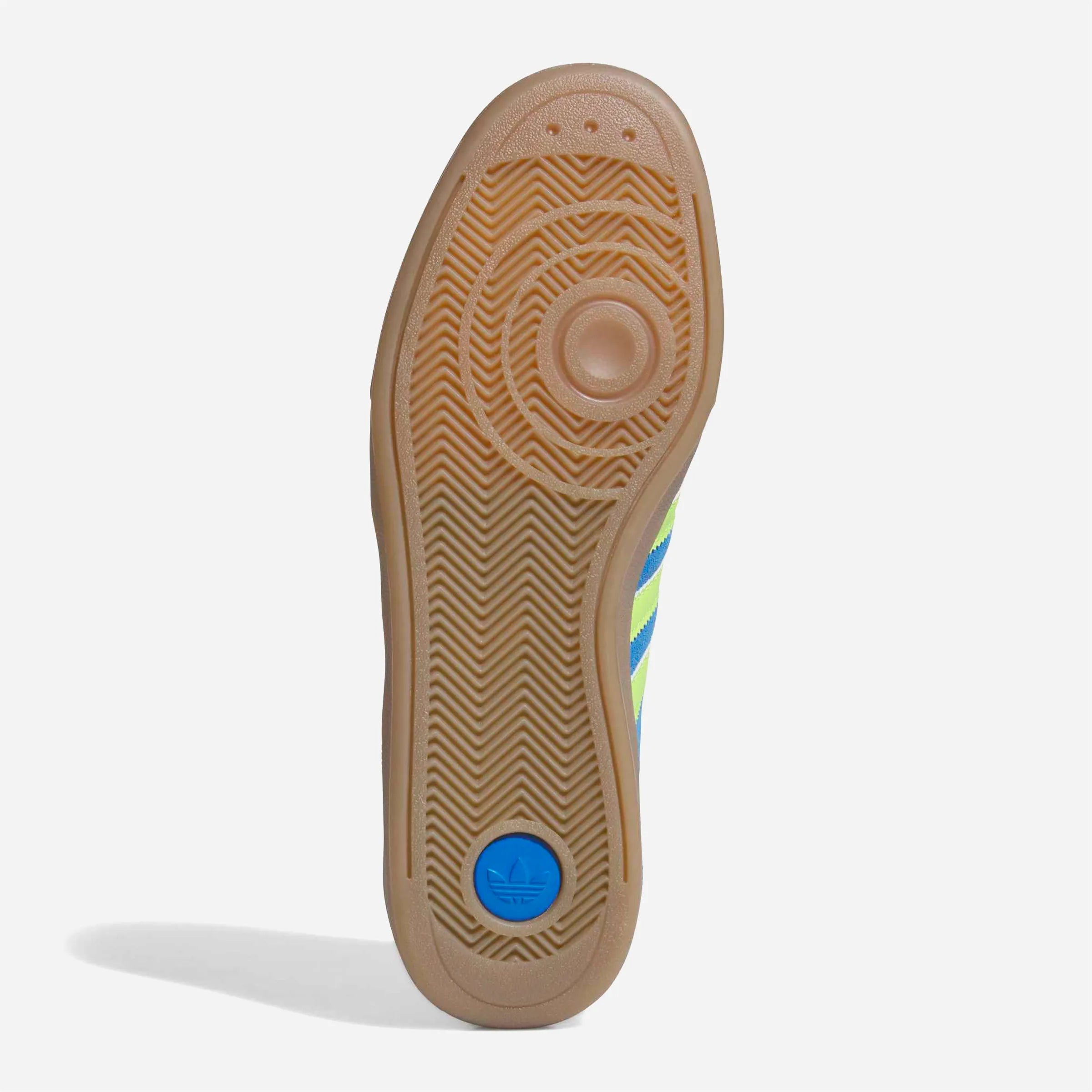 Semelle extérieure en caoutchouc gomme marron avec point de pivot bleu.