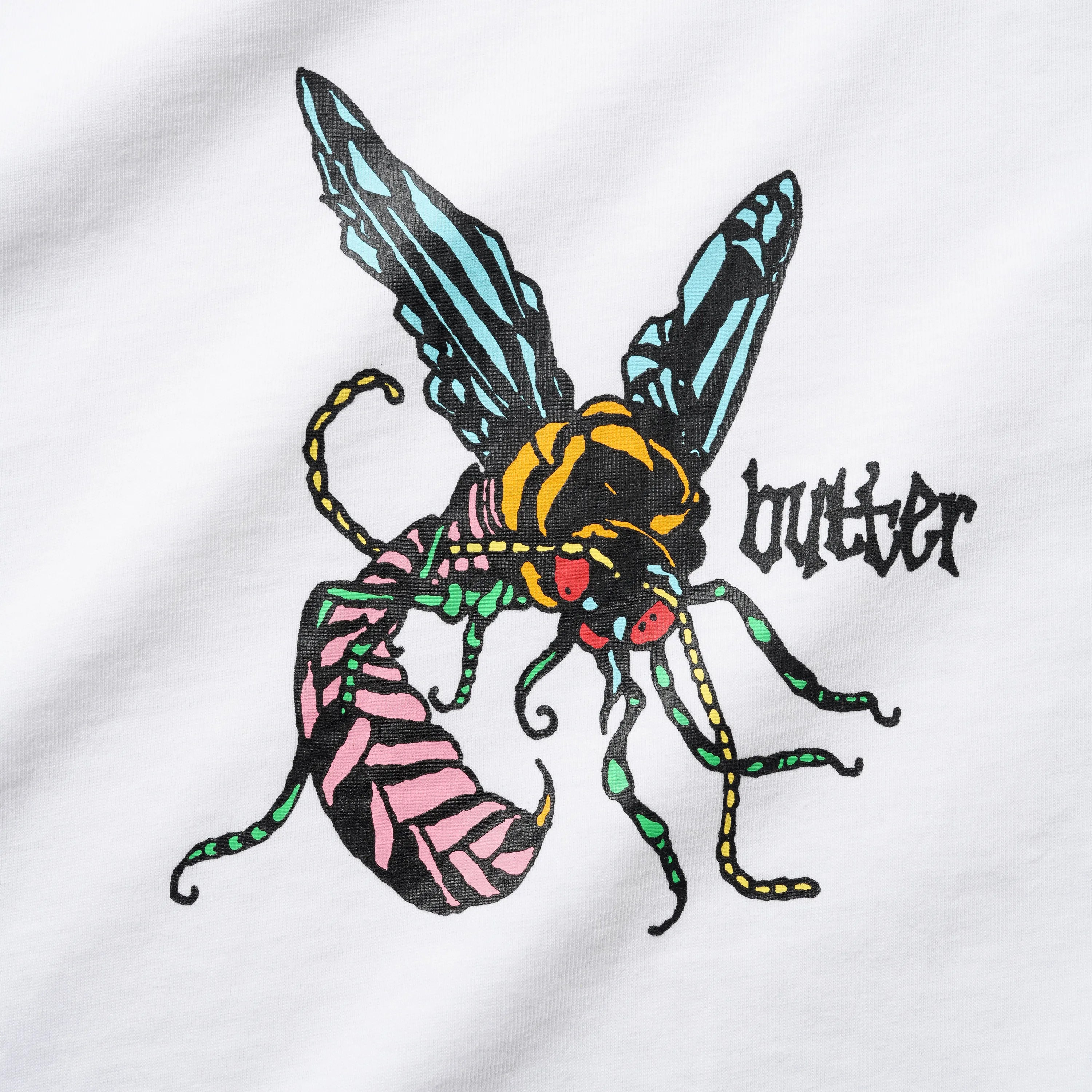 Close up on the Butter Goods screen print showing a colorful stylized pink, blue, and green wasp next to a gothic logo.