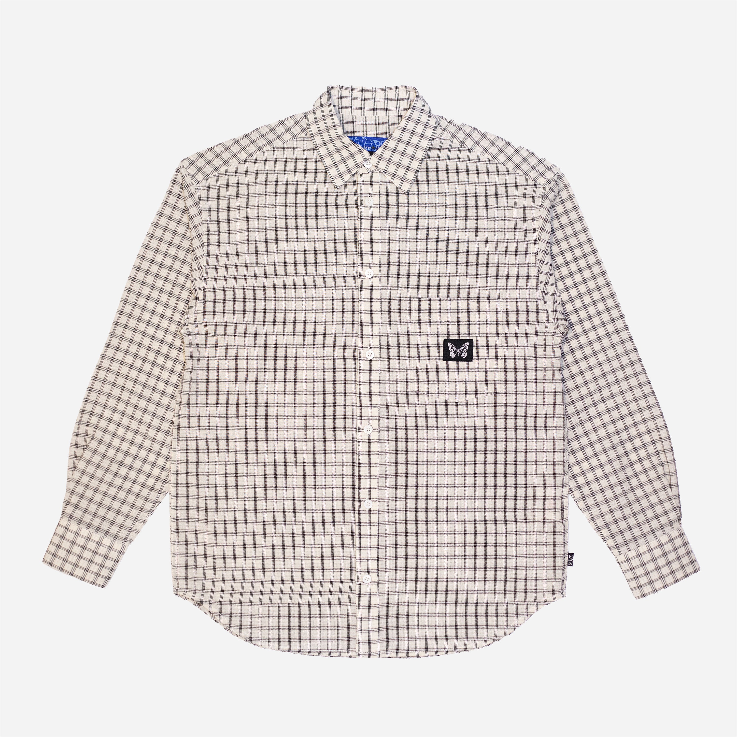 Chemise à manches longues à carreaux fins de la marque Bye Jeremy, modèle Supper Shirt, avec un patch logo papillon noir et blanc sur la poche poitrine.vue de face