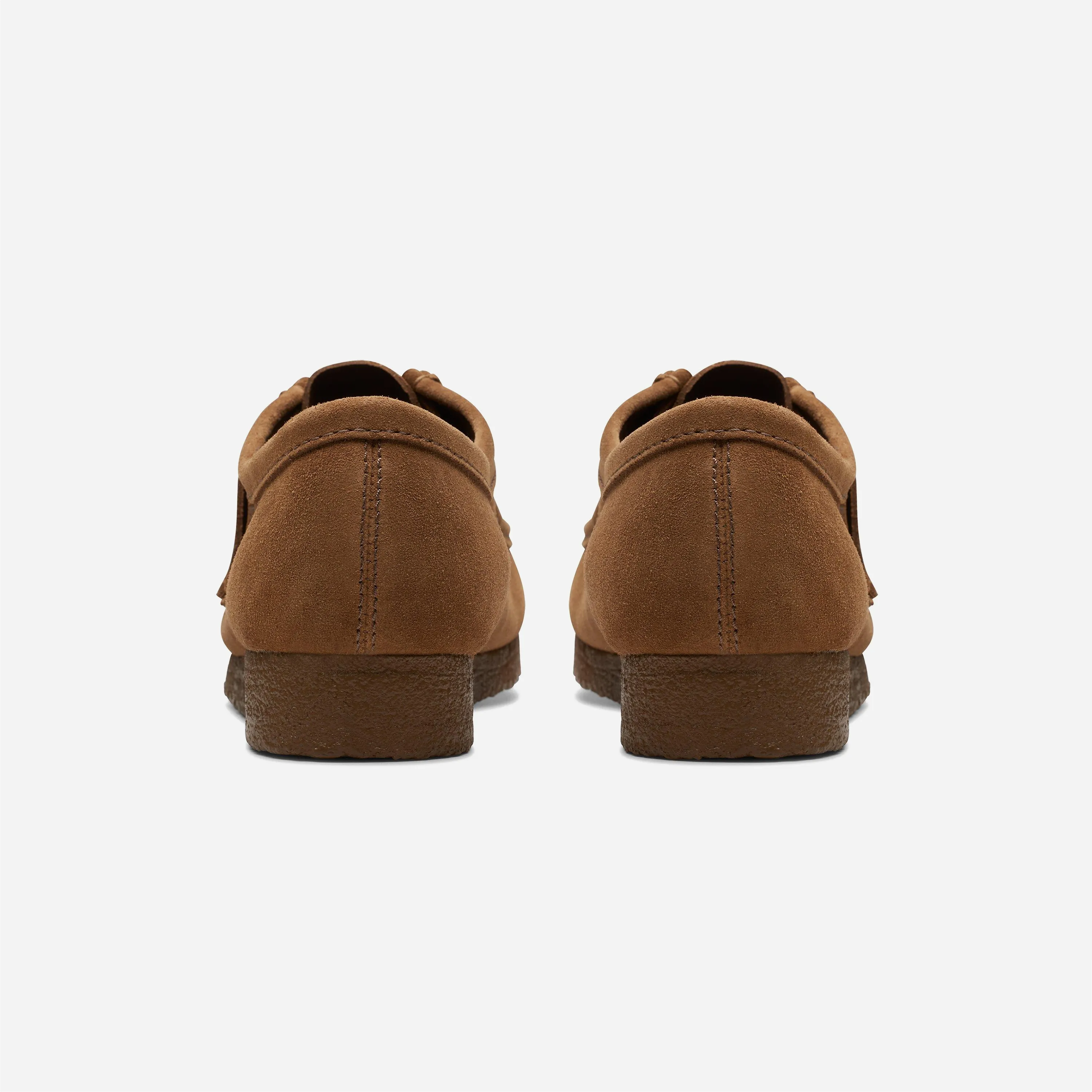 Back view of the brown Clarks Wallabee shoes sitting on the thick natural crepe sole.
