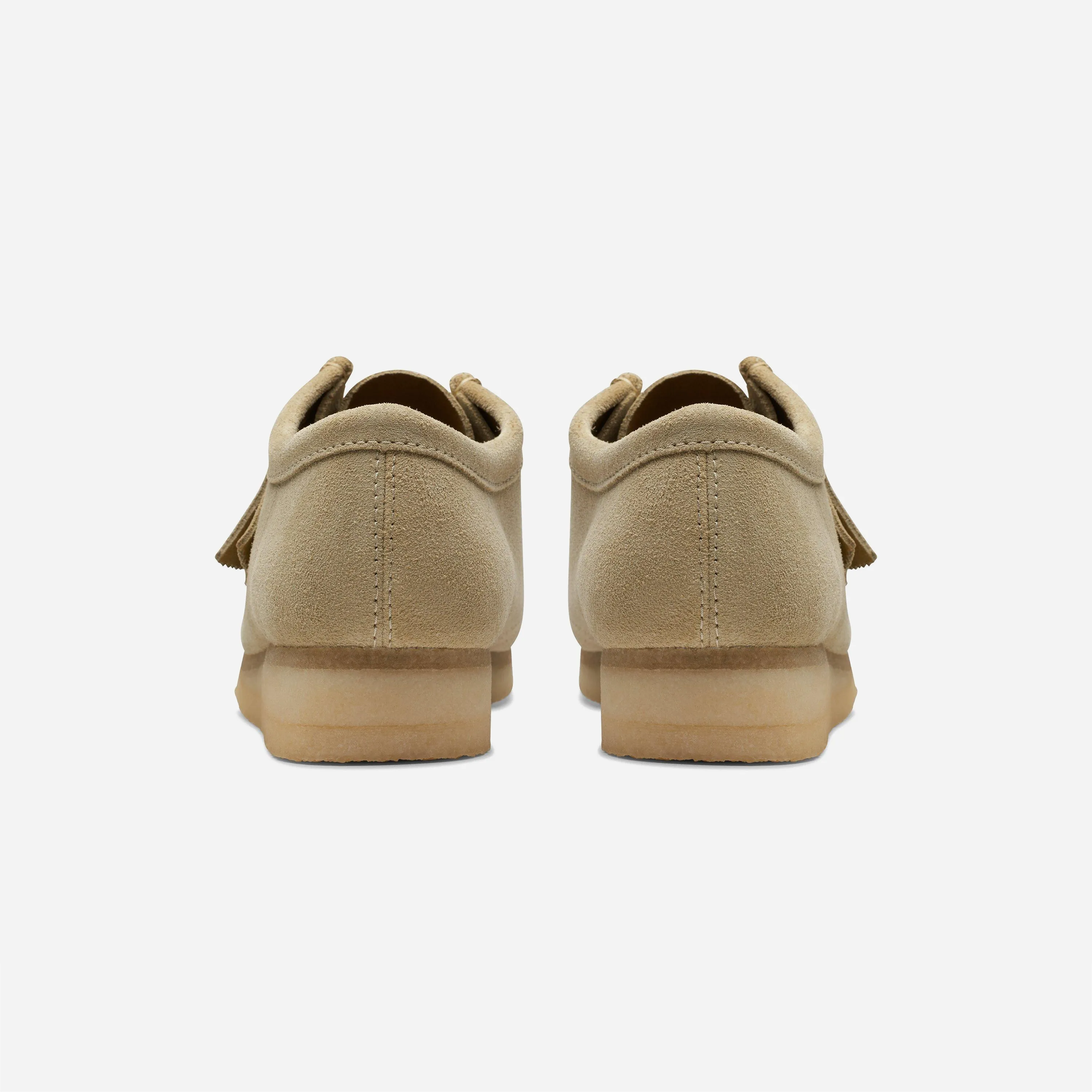 Back view of the beige Clarks Wallabee shoes resting on the thick natural crepe sole.