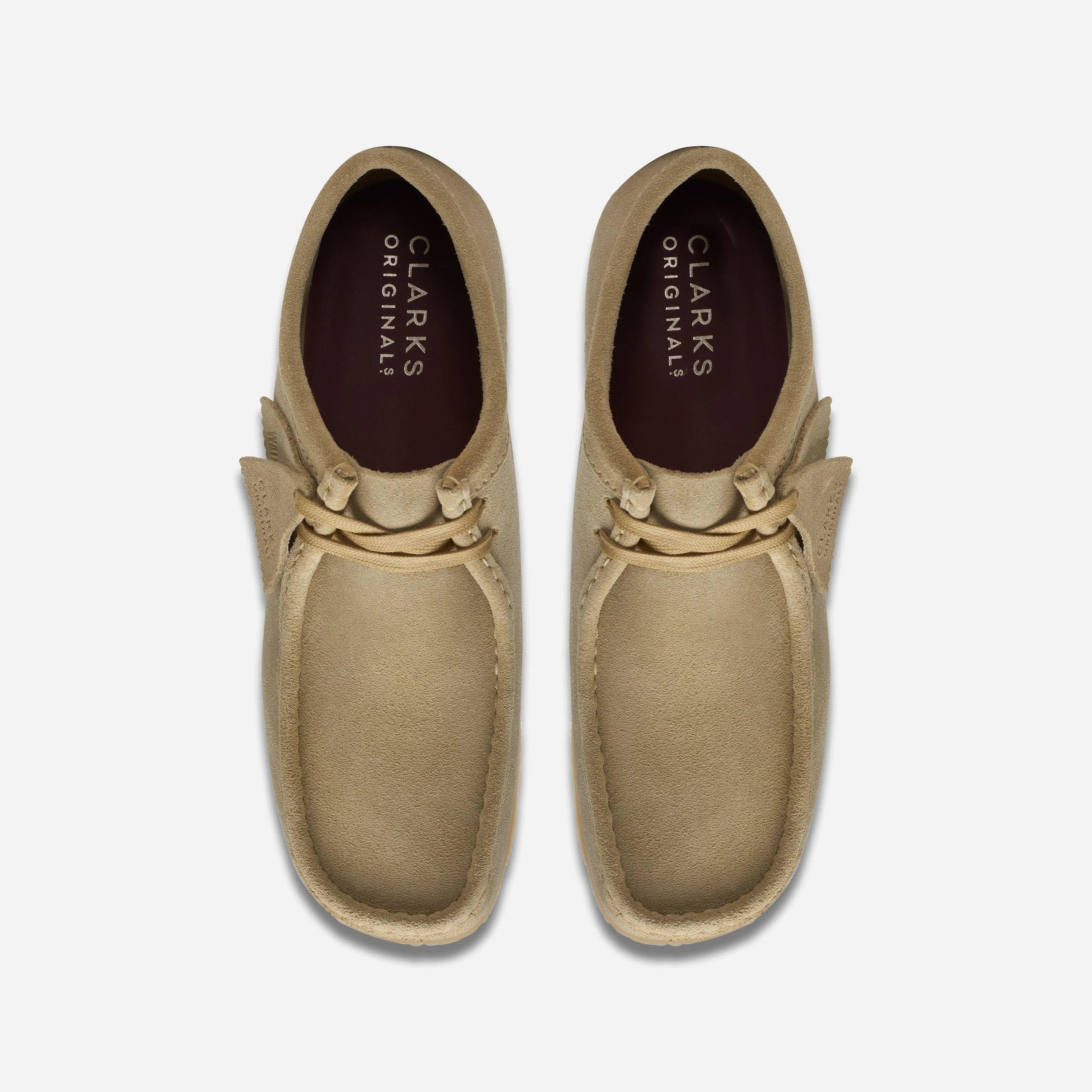 Top-down view of the Clarks Wallabee Maple Suede shoes highlighting the asymmetrical structural silhouette and inner lining.