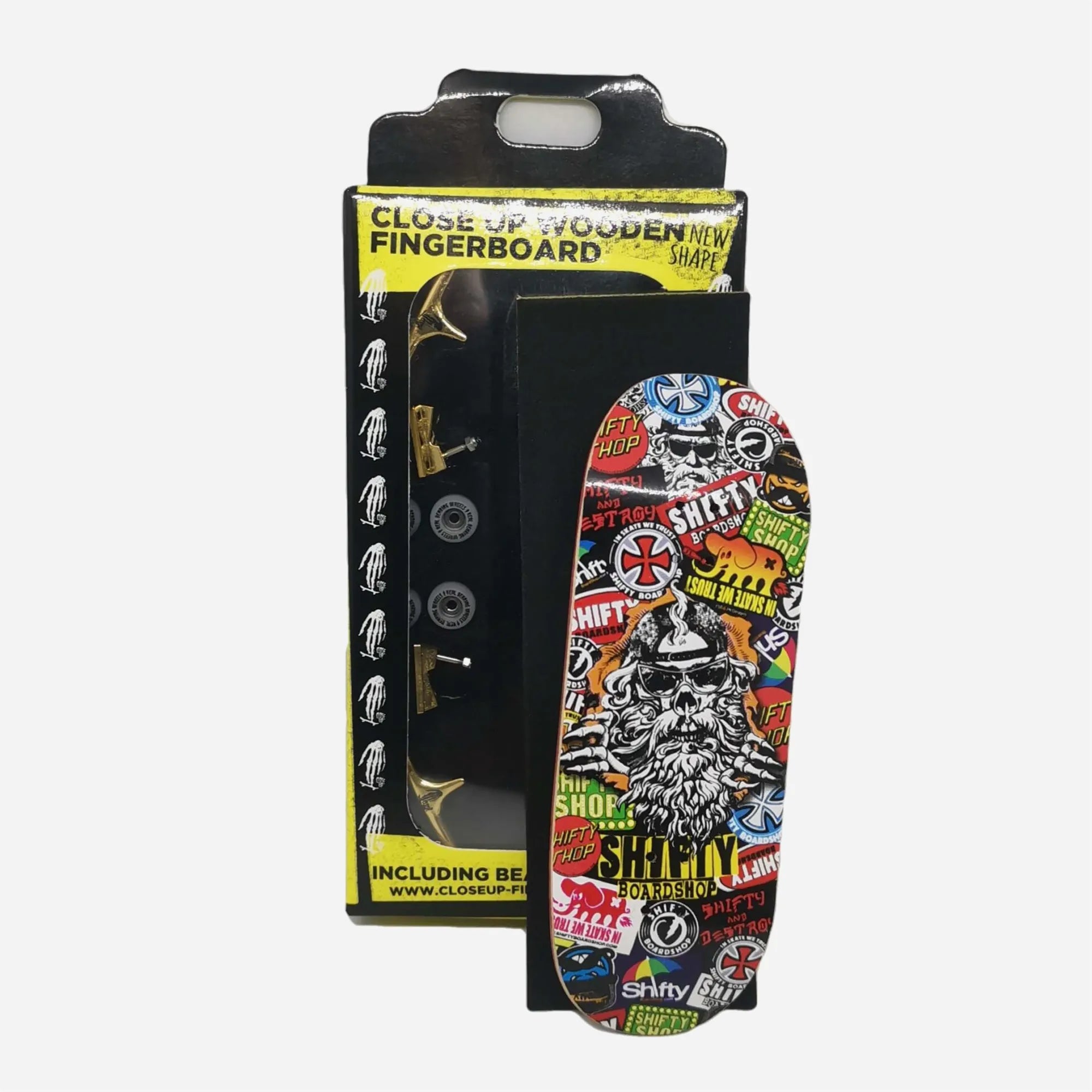 Packaging fingerboard complet Close Up x Shifty Dijon avec plateau motif stickers et trucks dorés.