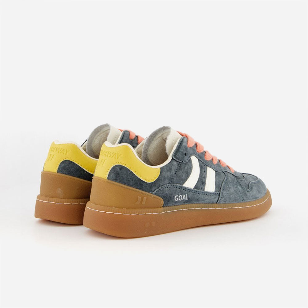 Talon jaune avec inscription GOAL et semelle épaisse en caoutchouc marron.