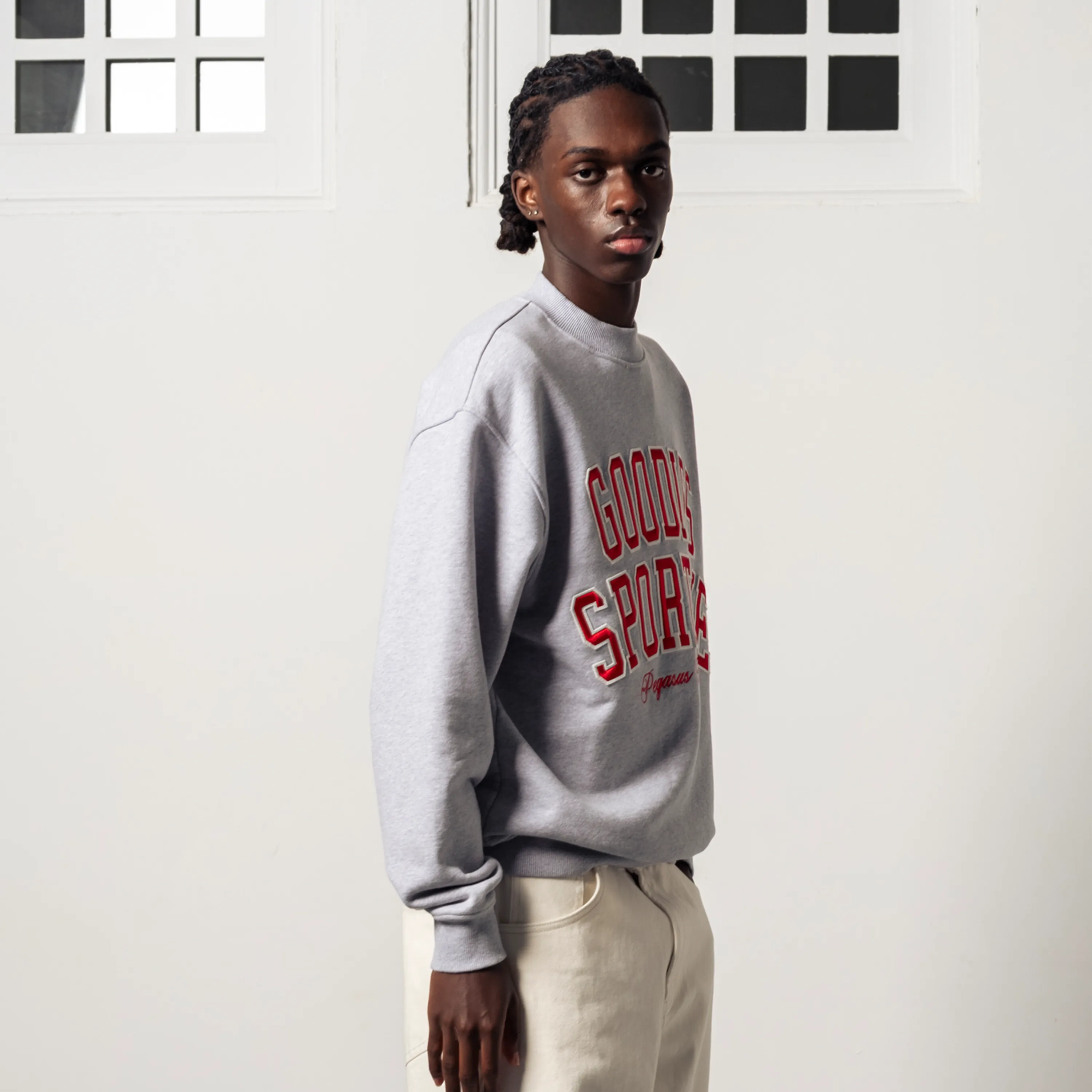 Side view showing the loose fit and dropped shoulders of the sweatshirt.