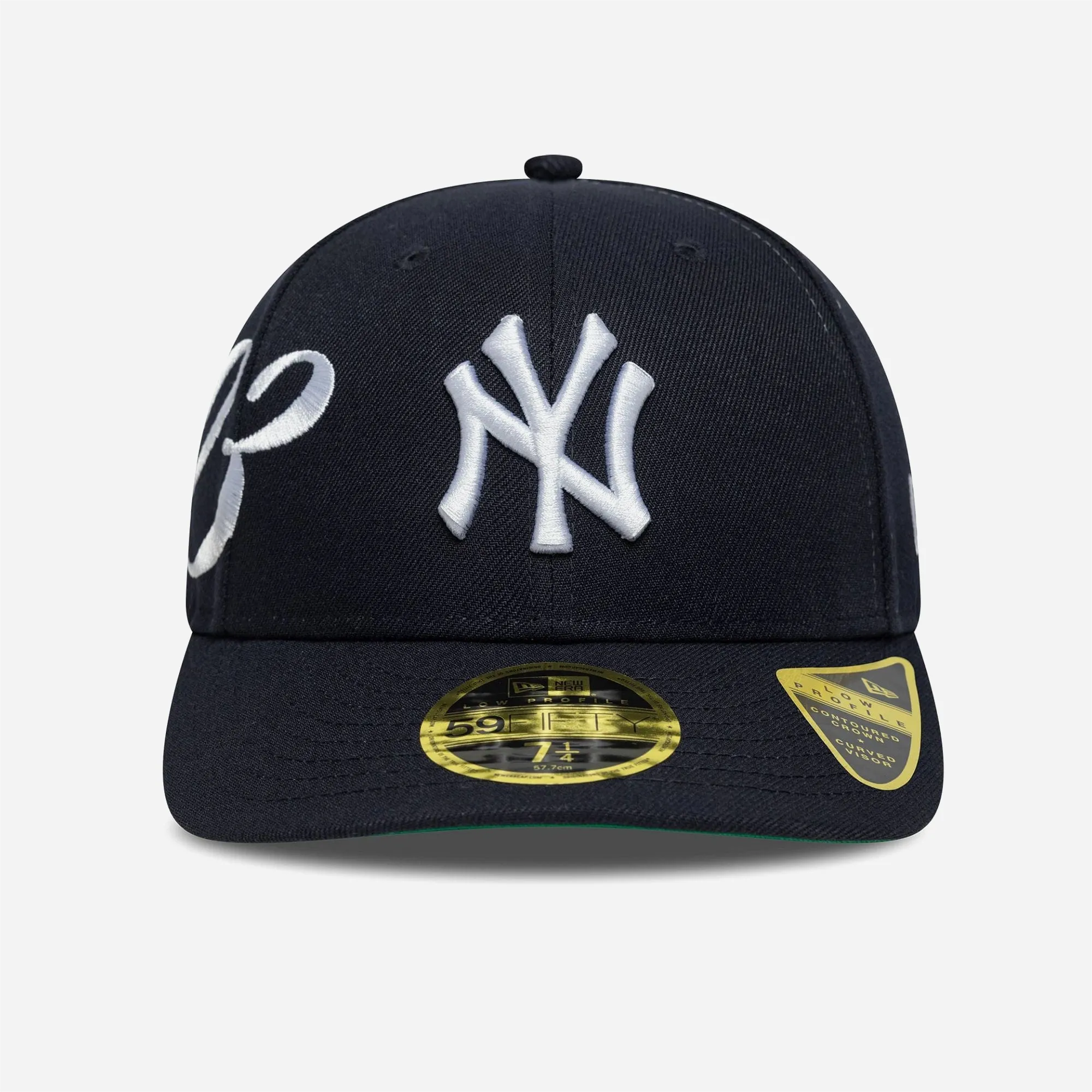 White NY logo embroidered on navy blue New Era Low Profile cap.