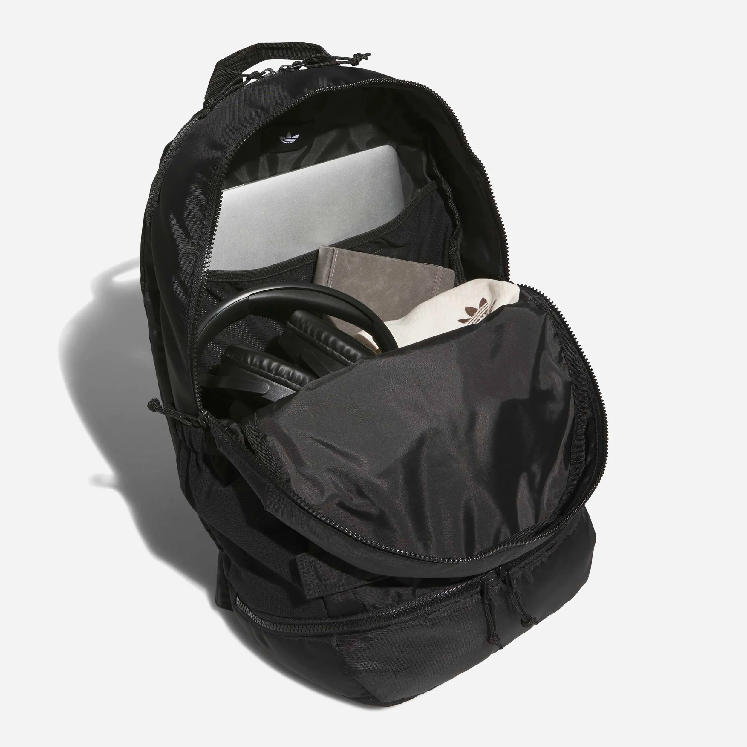 Interior compartment of the Adidas FSBS backpack with laptop sleeve and storage