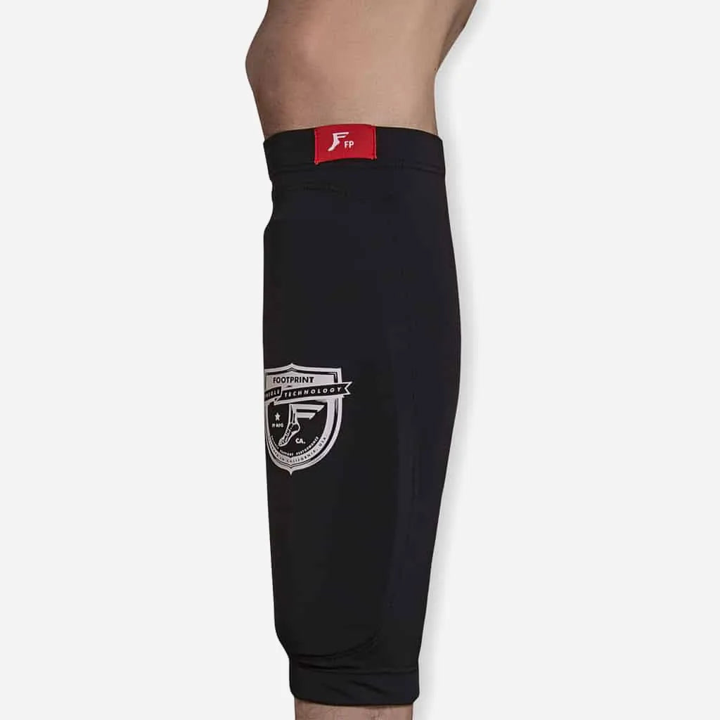 Footprint shin sleeve worn under pants during a skate session