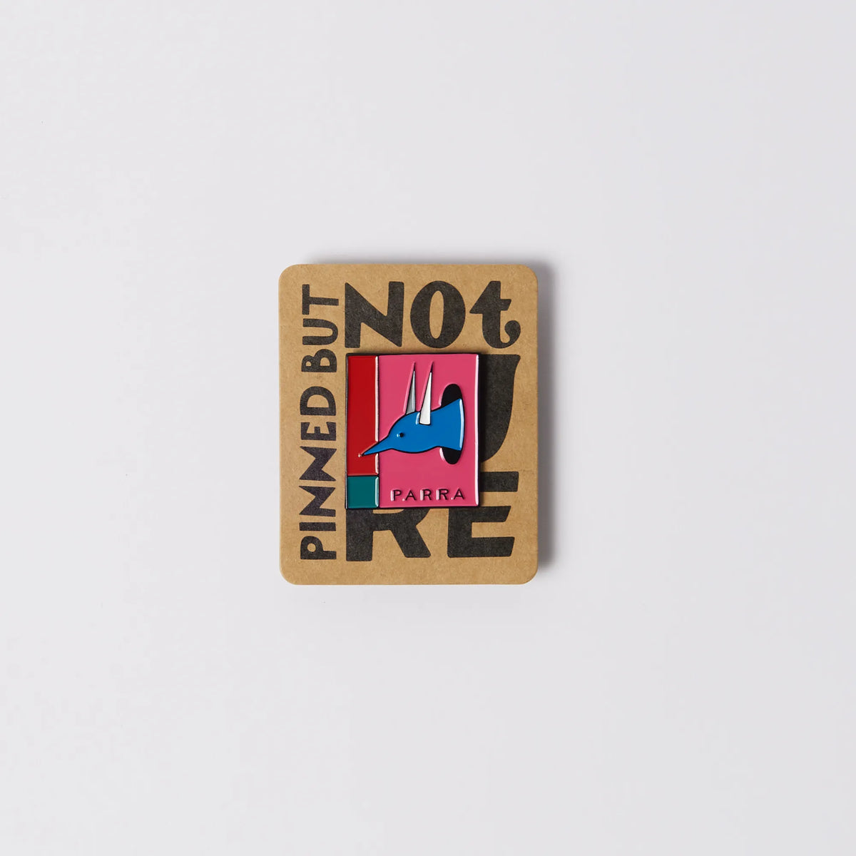 Parra The Hunted, pink hard enamel pin on kraft backing card, front view