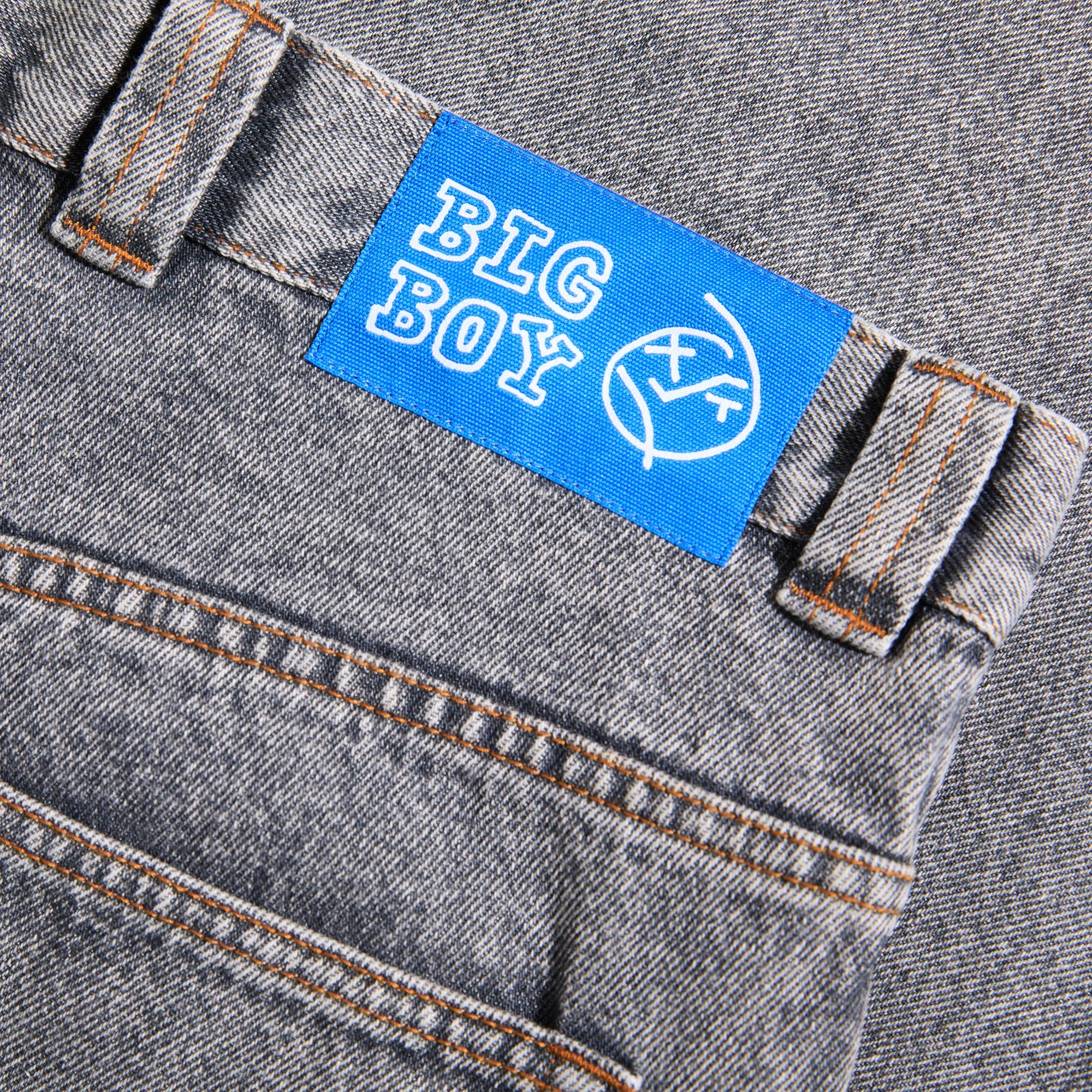 Detail of the blue woven waist label on the grey Polar Skate Co Big Boy streetwear jeans.