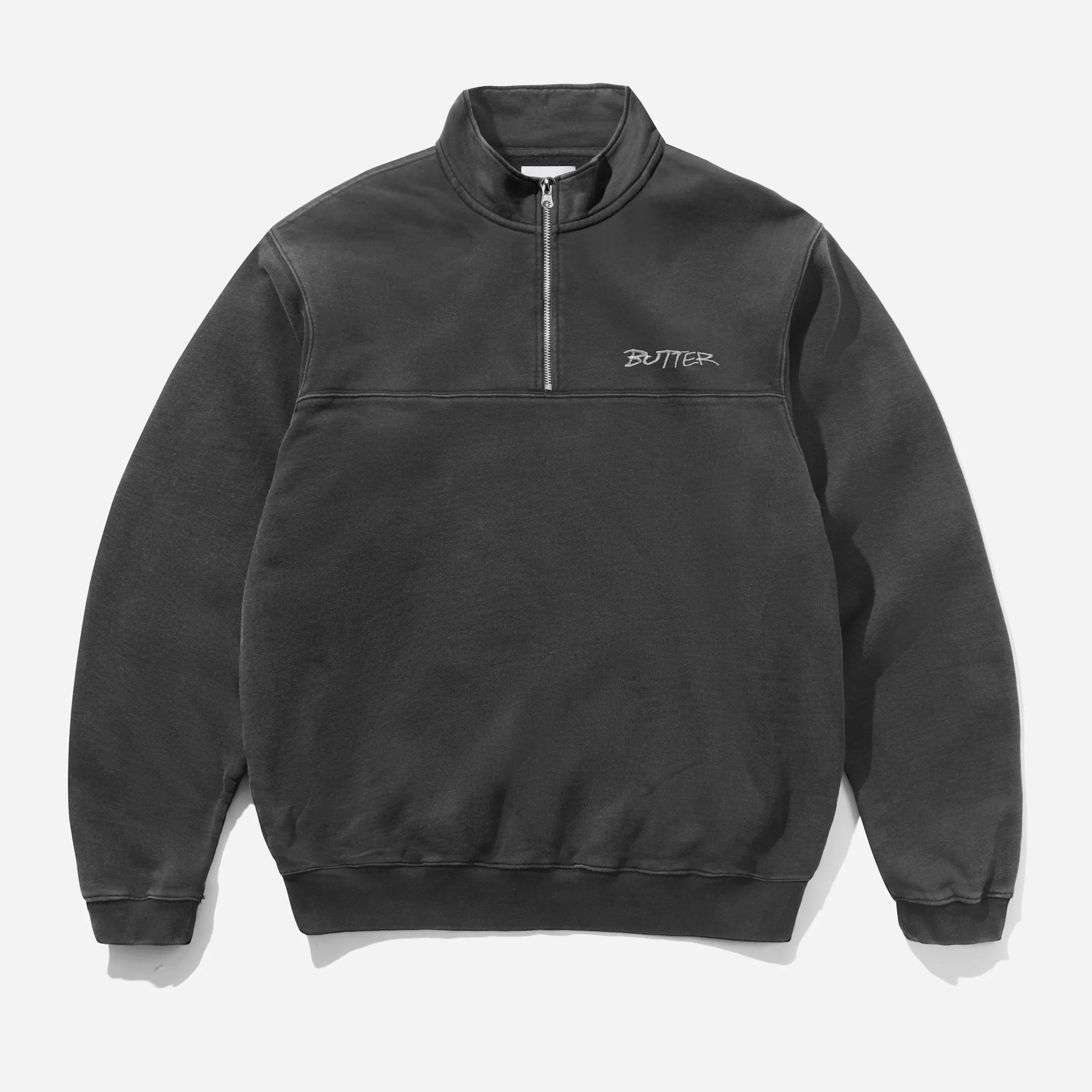 Front flat view of the Butter Goods Men's Panel 1/4 Zip Sweater in Washed Black fleece