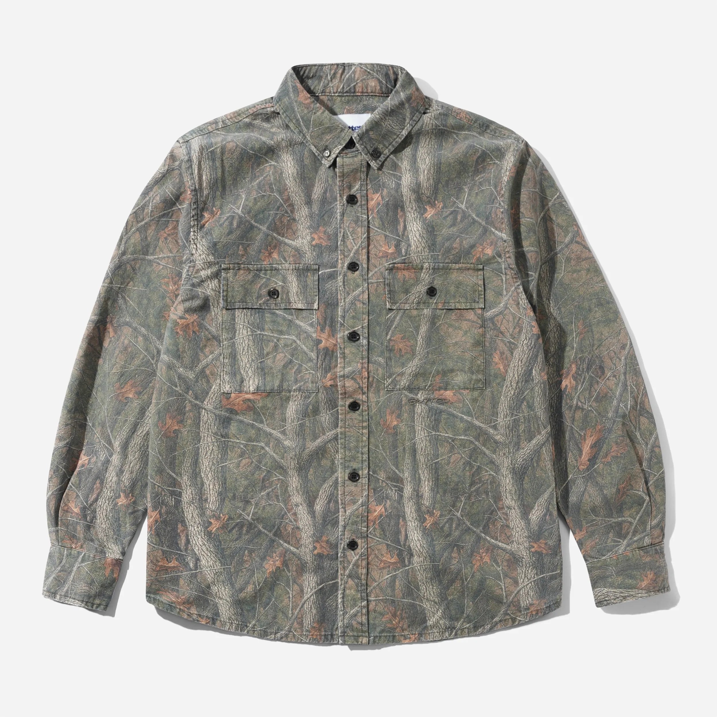 Front flat view of the Butter Goods Men's Yard Long Sleeve Shirt in Forest Camo