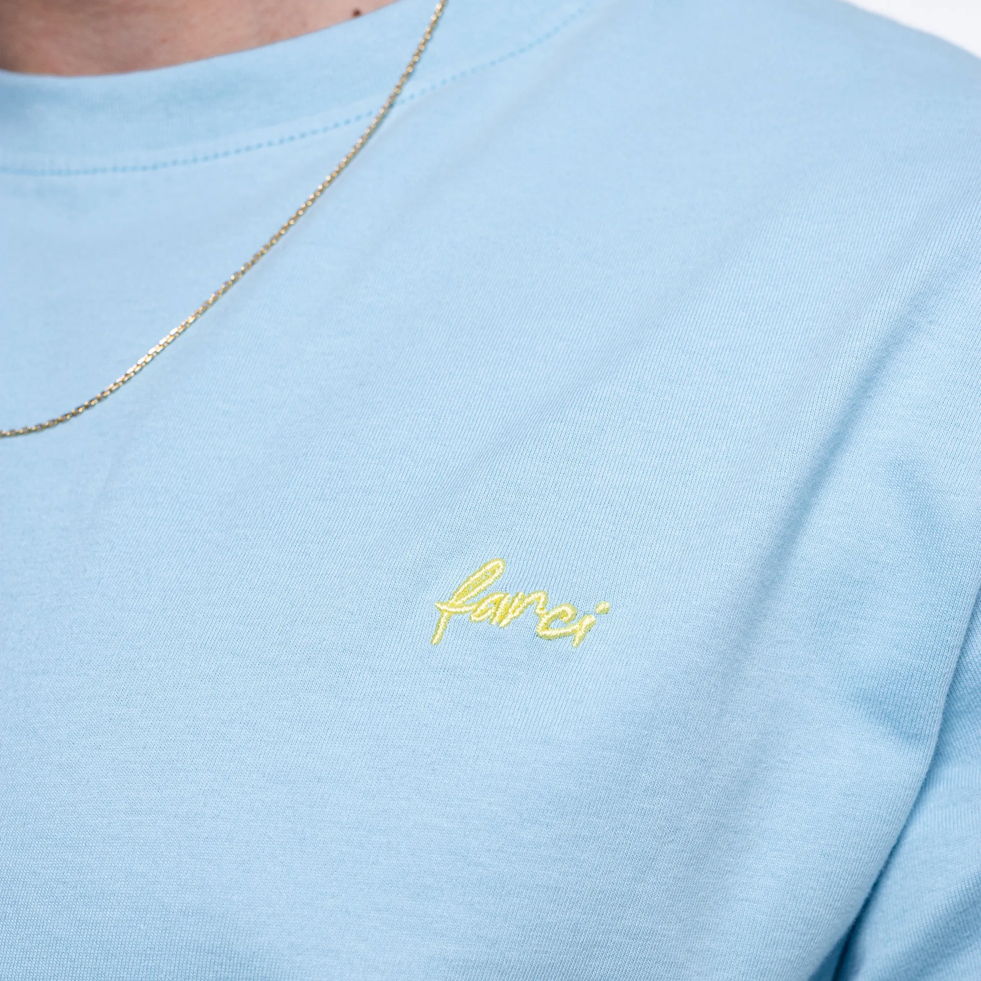 Detailed close-up of the high-density embroidery on the premium Farci Studio streetwear t-shirt.