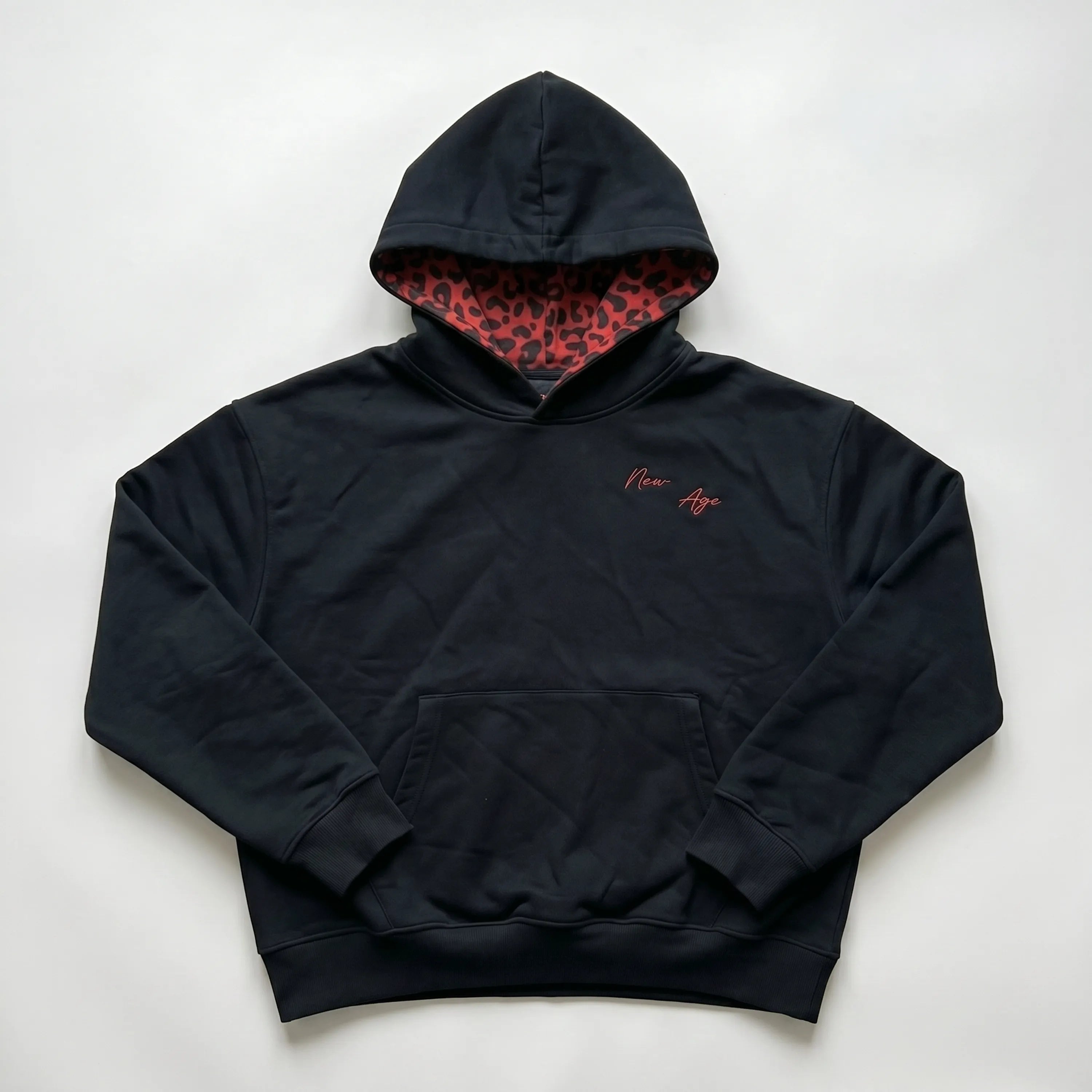 Maison New Age black hoodie with red embroidery.
