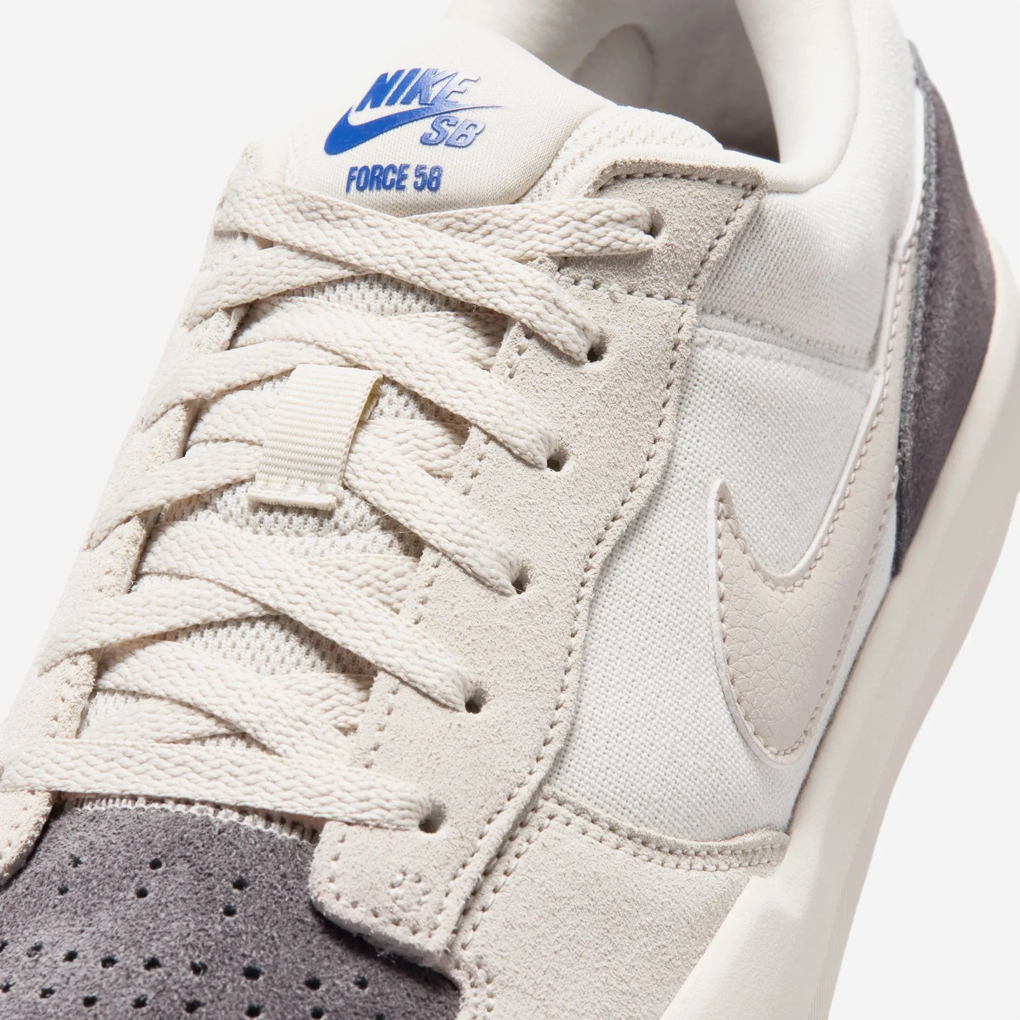 Close-up of perforated toe and blue Swoosh on Nike SB Force 58 light colorway