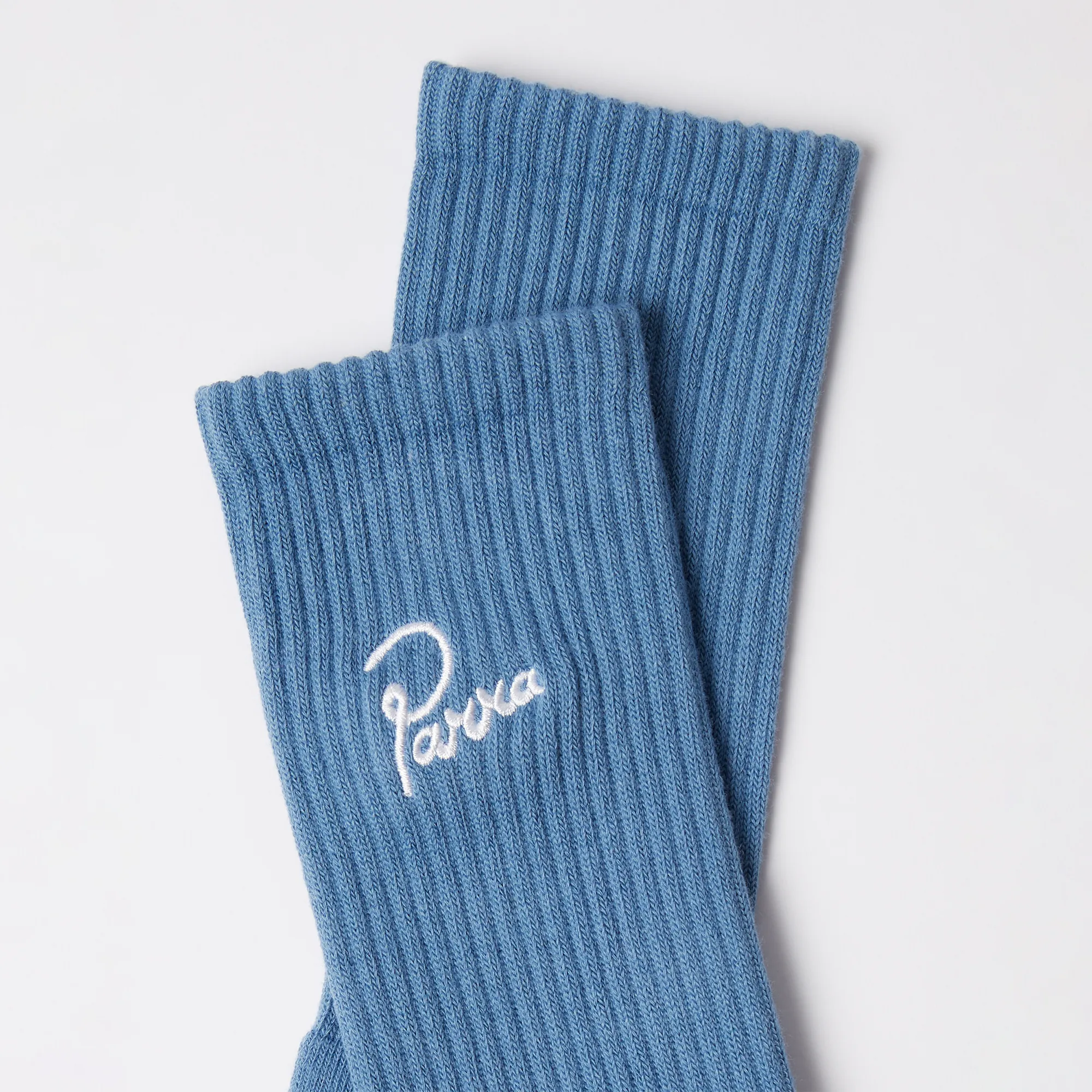 Detail of the Parra signature embroidery on blue socks.