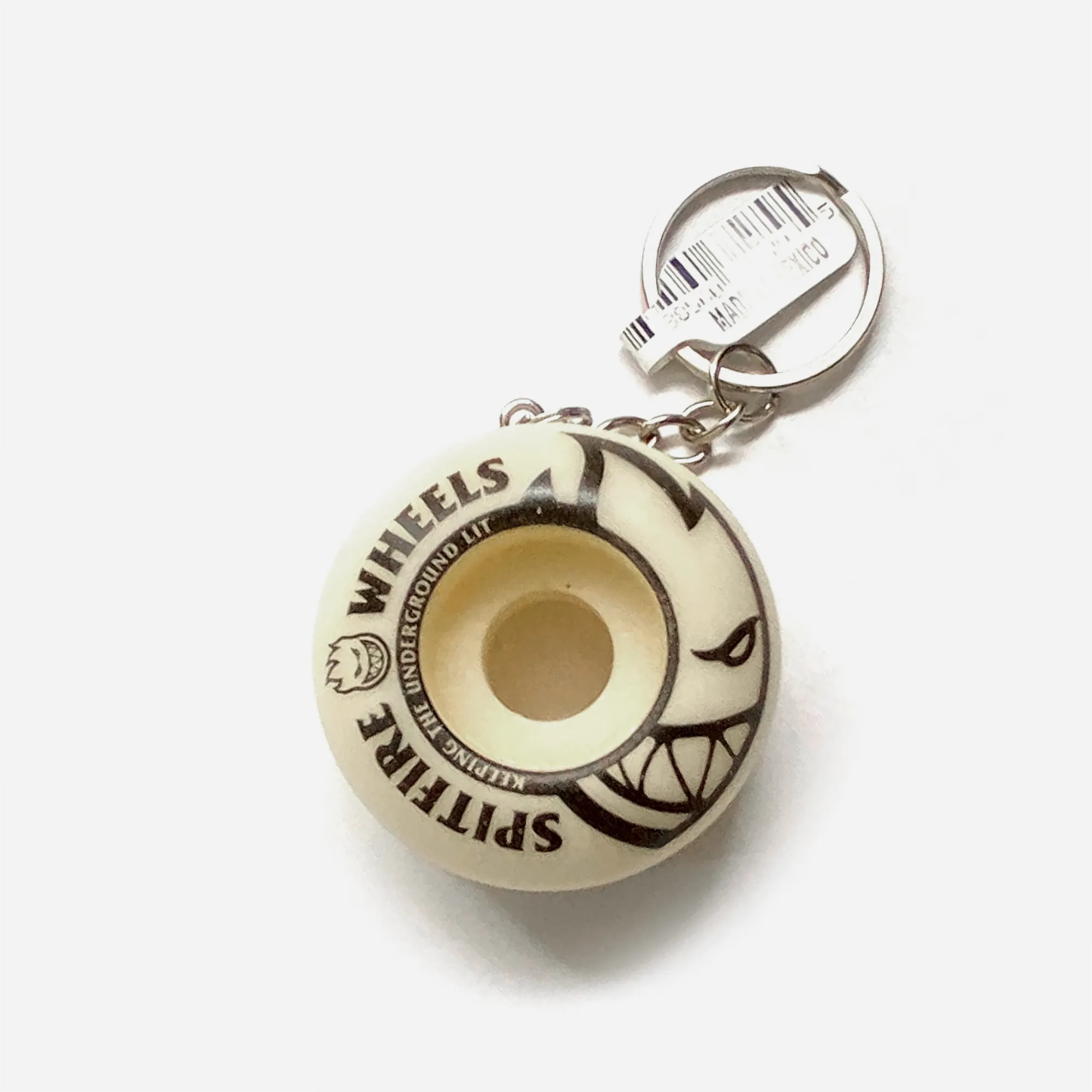 Spitfire Wheels keyring, replica skateboard wheel in natural colour with Keeping the Underground Lit logo.