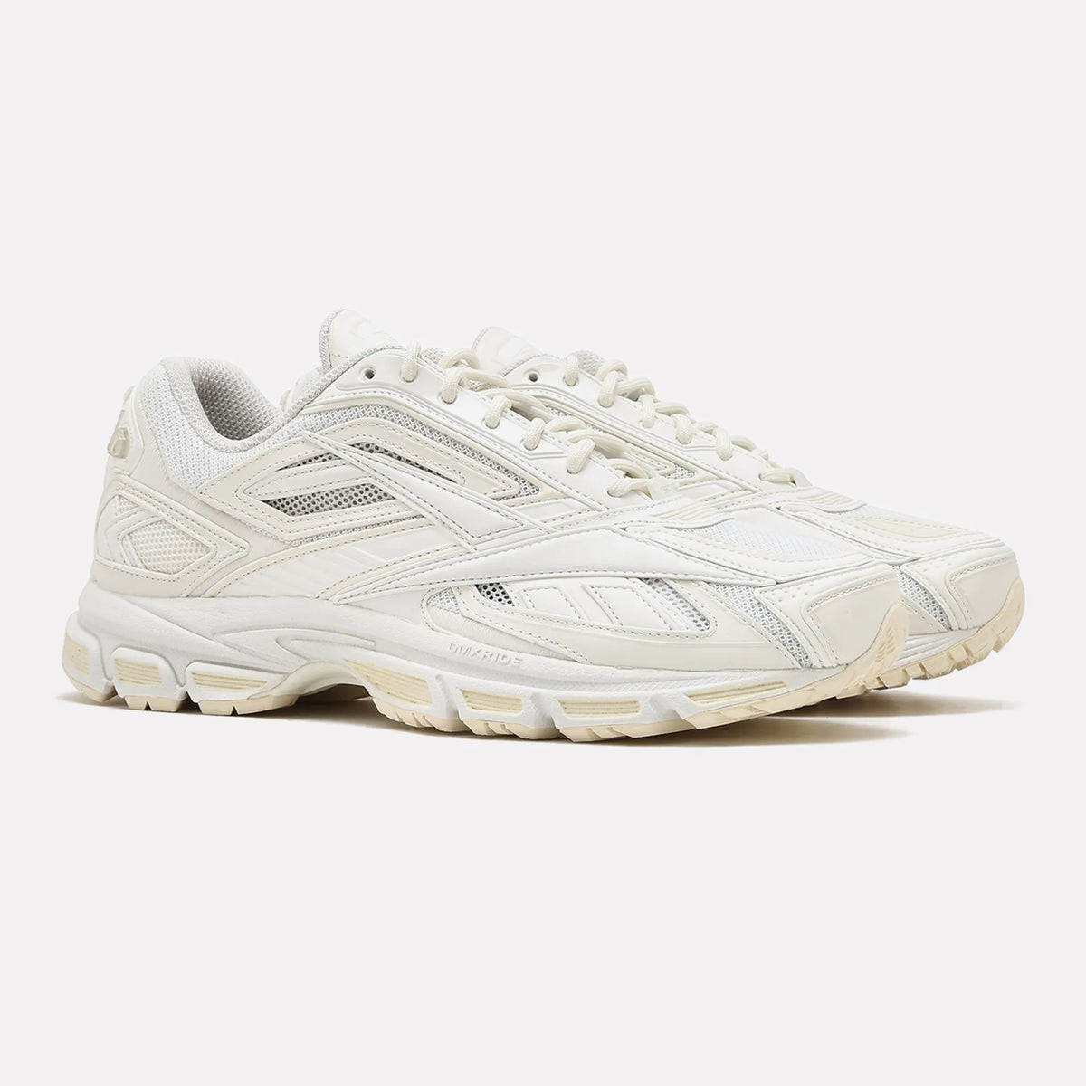 Pair of Reebok LTD Premier Road Ultra Chalk Vintage Chalk sneakers, off-white mesh, cream overlays and round braided laces, three-quarter view