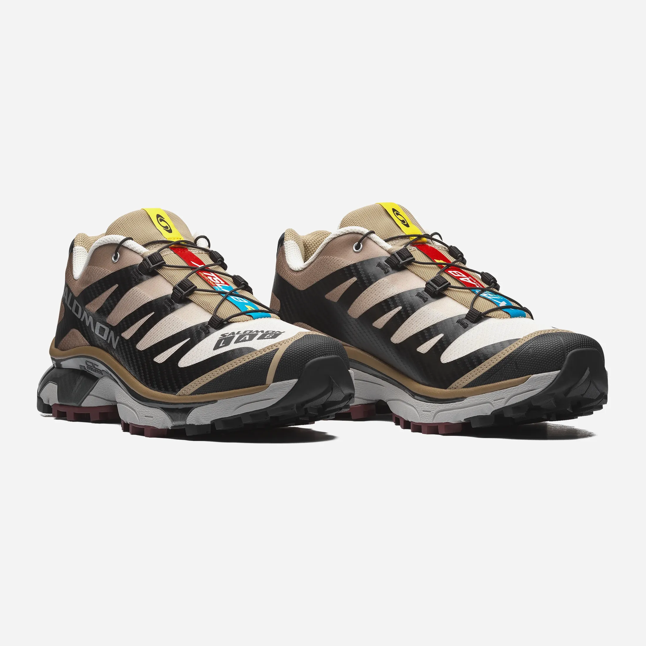Front view of the black and tan Salomon XT-4 OG shoe showing the Quicklace system and anti-debris mesh.