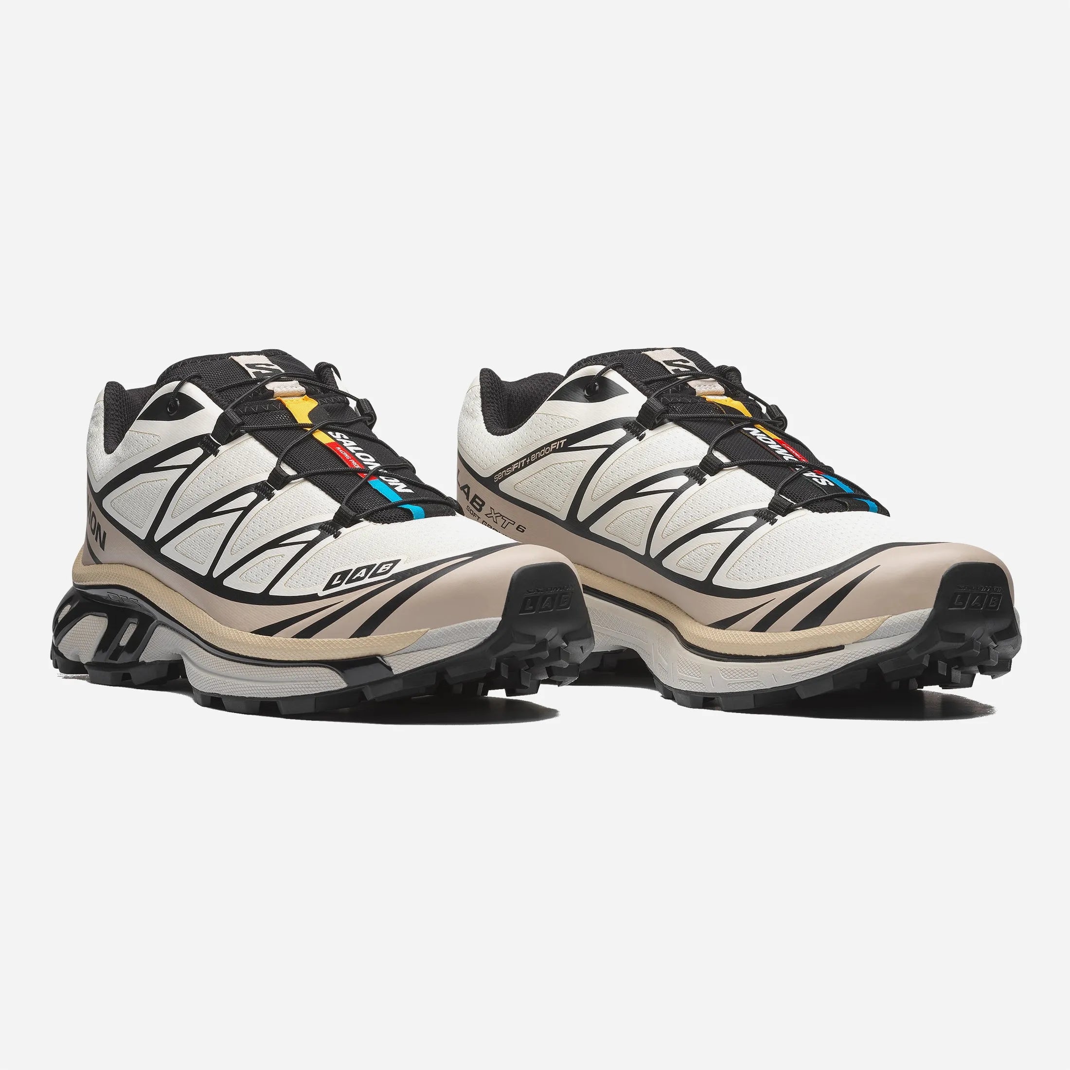 Front view of the beige and black Salomon XT-6 shoe featuring the Quicklace system and stone guard.